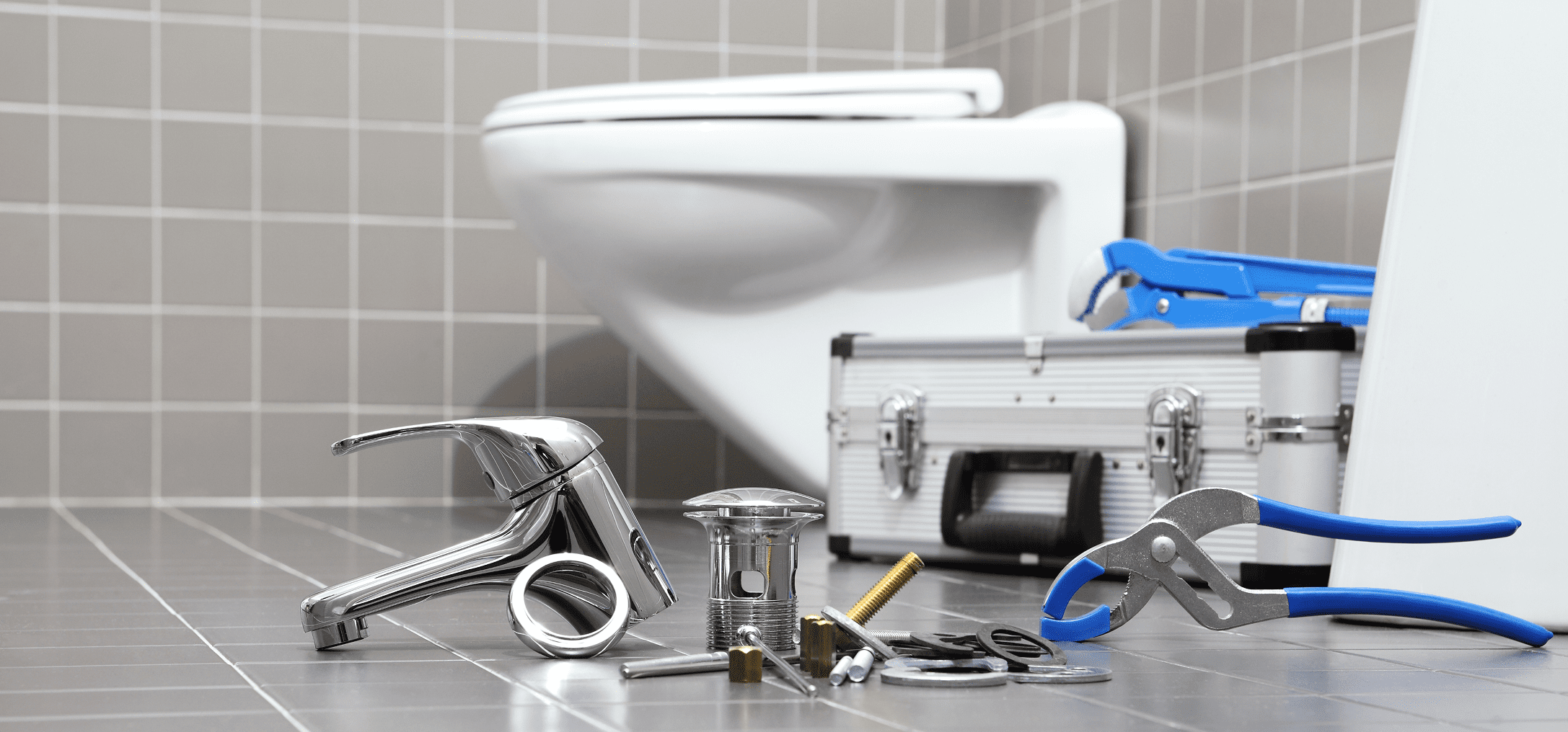 Plumbing tools on bathroom floor