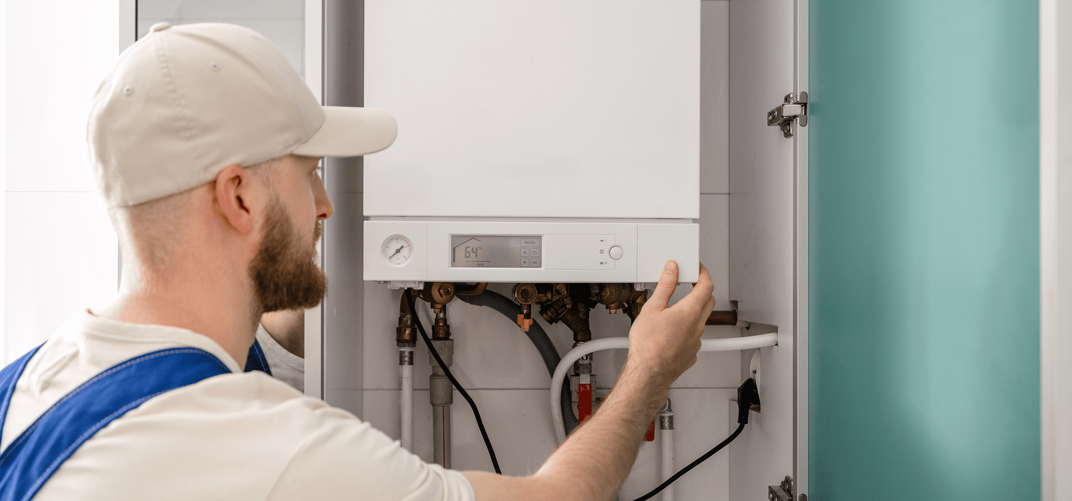 Plumber adjusting water heating unit