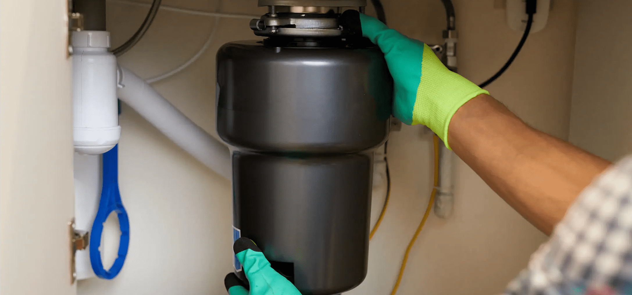 Person installing a garbage disposal unit