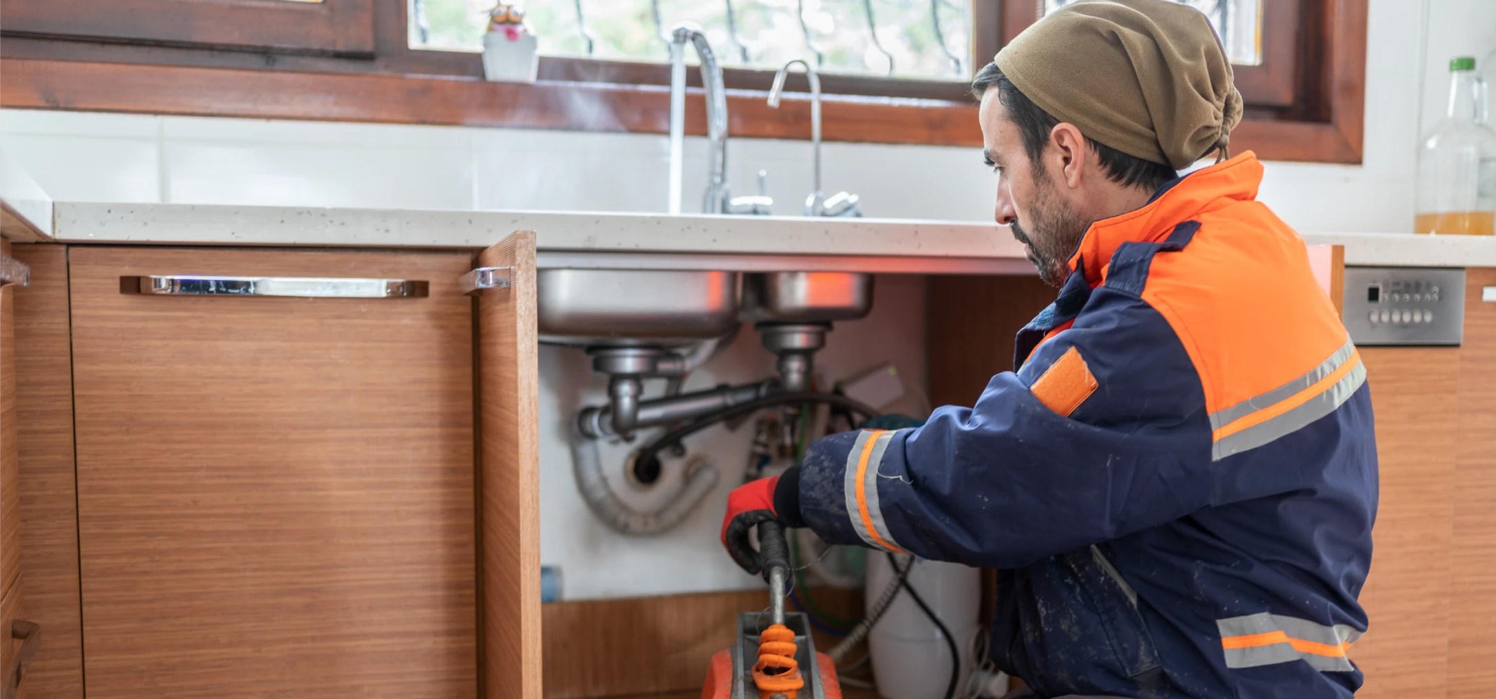 Maintenance technician in kitchen workspace