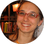 Smiling person with glasses and books
